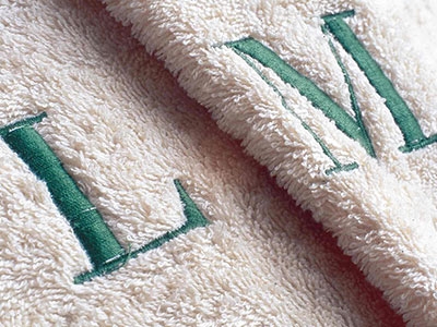 It's possible to put embroidered logo or initials on terrycloth